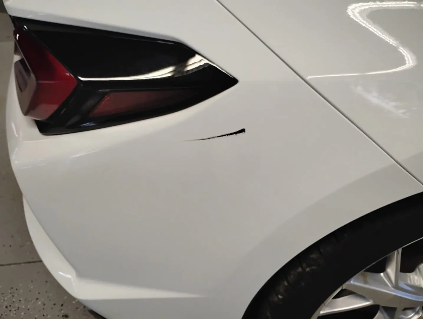 Car with scratch on rear panel.