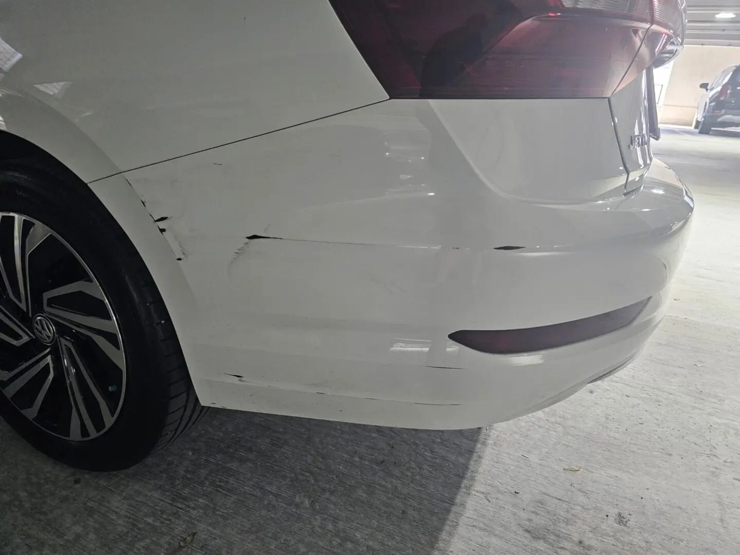 Car with scratches on rear bumper.