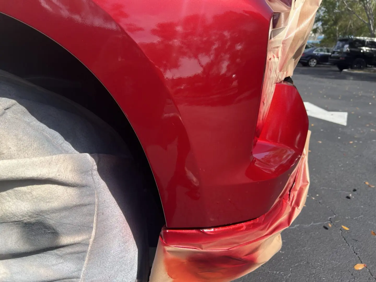 Red car bumper with fresh paint job.