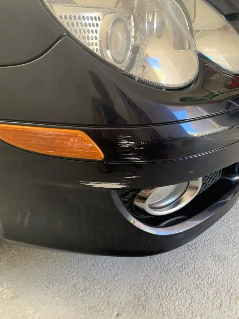 Car bumper with visible scratch marks.