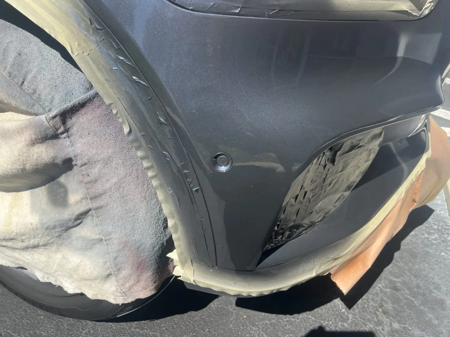 Car bumper with protective covering during repair.