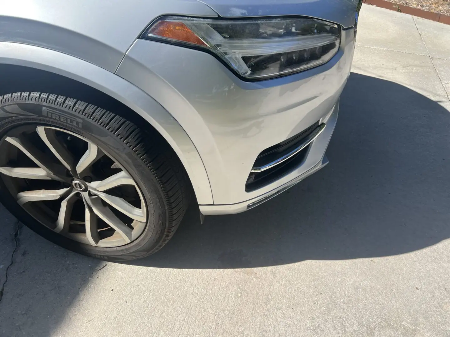 Front view of a silver car's wheel.