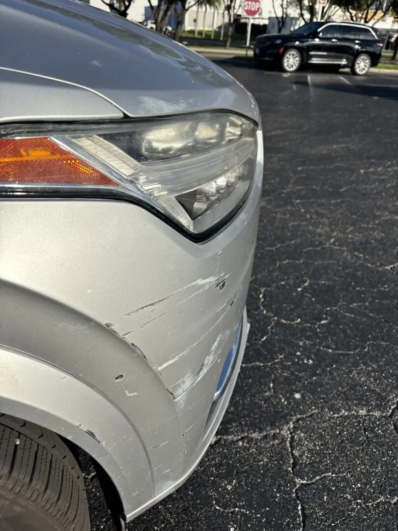 Car with scratches on front bumper.