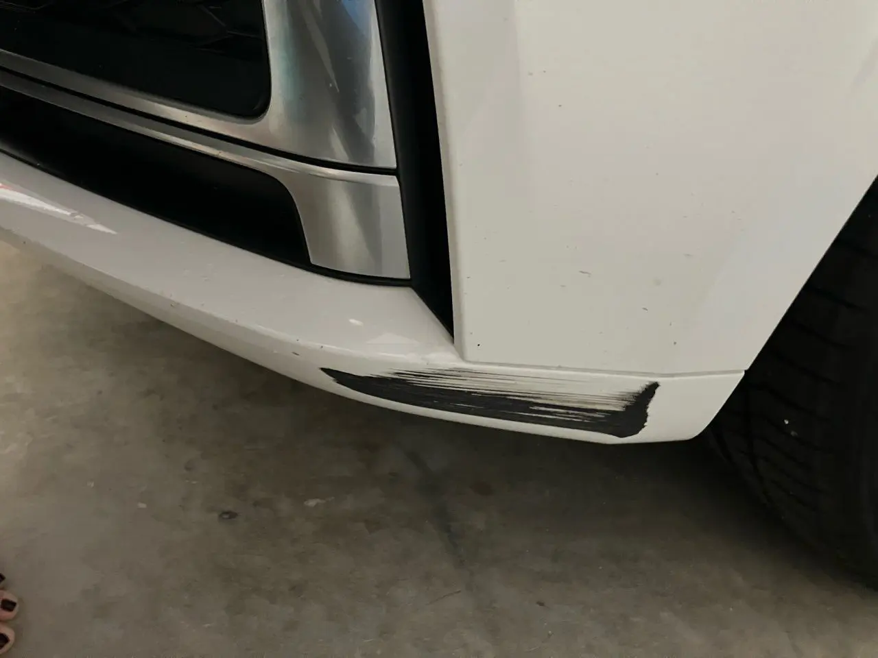 Car bumper with scratch mark visible.
