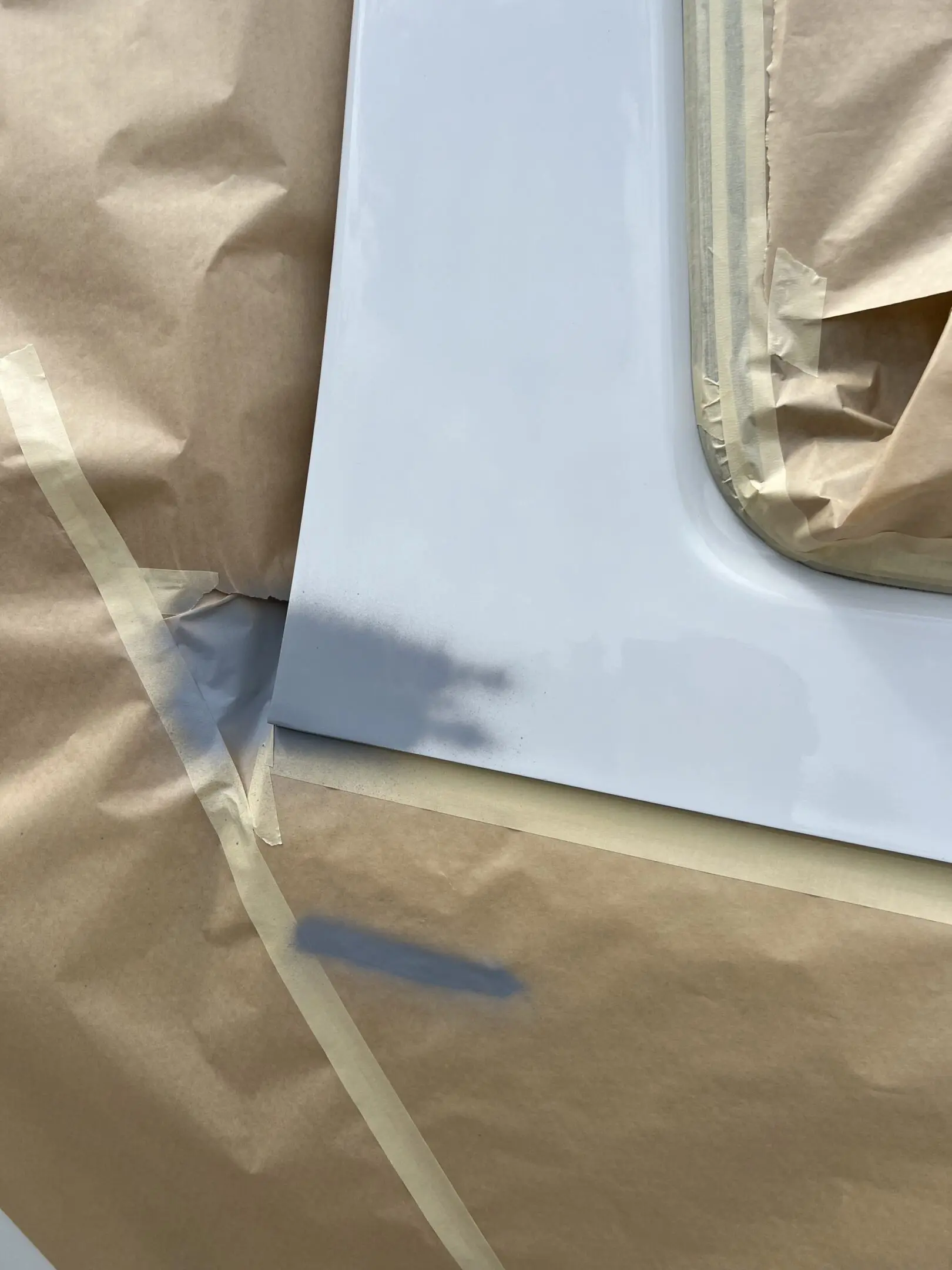 A car door being masked for painting or repair.