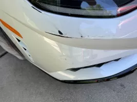 Car bumper with visible scratches and scuffs.