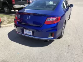 Blue Honda car parked on the street.